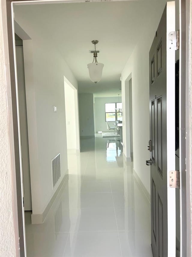 hall with light tile patterned floors