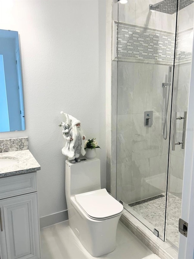 bathroom featuring toilet, vanity, and an enclosed shower