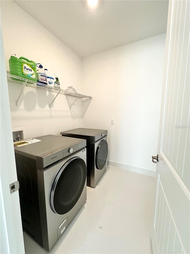 washroom featuring washer and clothes dryer