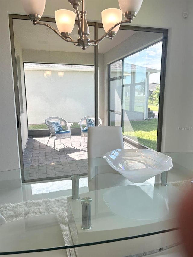 dining area with an inviting chandelier