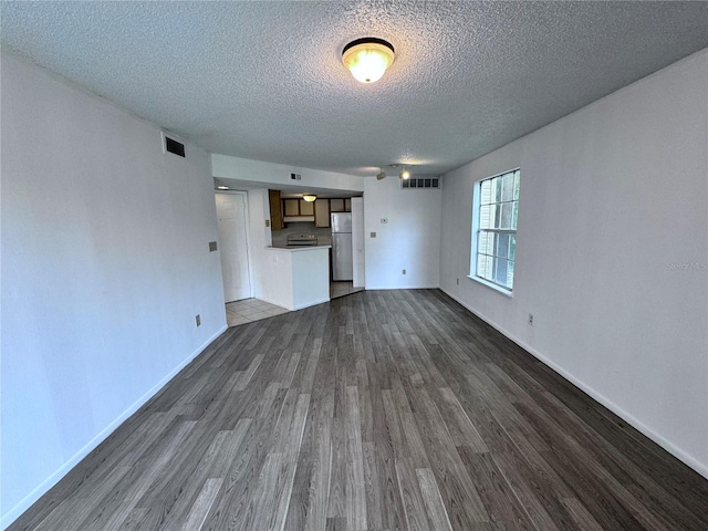 unfurnished living room with dark hardwood / wood-style floors and a textured ceiling