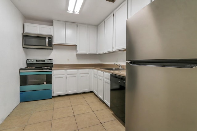 kitchen featuring sink, white cabinetry, light tile patterned floors, and stainless steel appliances