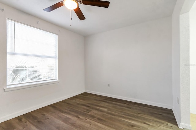 spare room with ceiling fan and dark hardwood / wood-style flooring