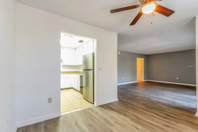 empty room with light hardwood / wood-style floors and ceiling fan