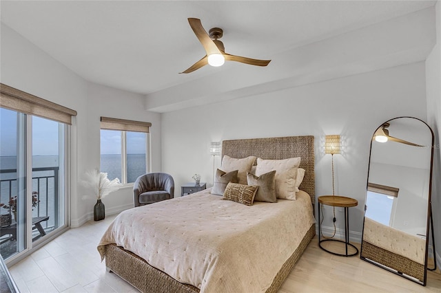 bedroom with access to exterior, ceiling fan, and baseboards