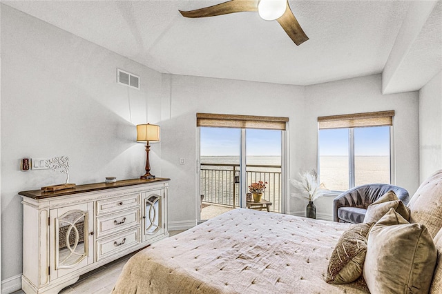 bedroom with access to exterior, visible vents, baseboards, ceiling fan, and light wood-style flooring