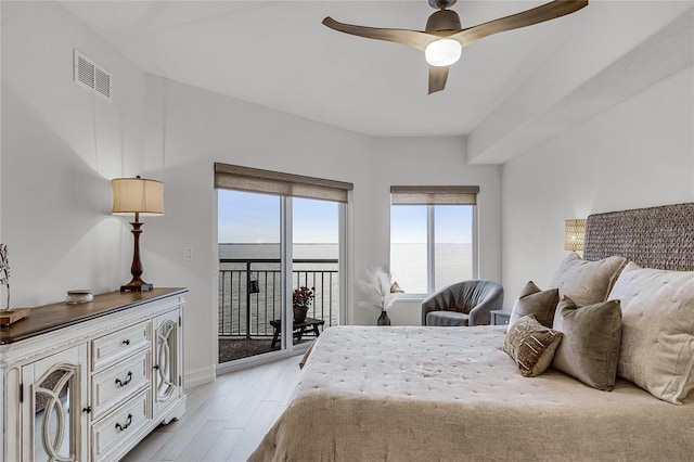 bedroom featuring visible vents, light wood-style flooring, a ceiling fan, baseboards, and access to exterior