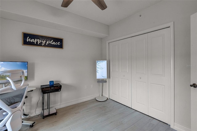 home office featuring ceiling fan, light wood-type flooring, and baseboards