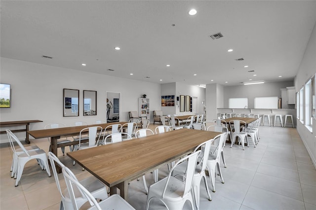 dining area with light tile patterned floors, visible vents, and recessed lighting