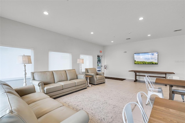 living area featuring recessed lighting, visible vents, and baseboards