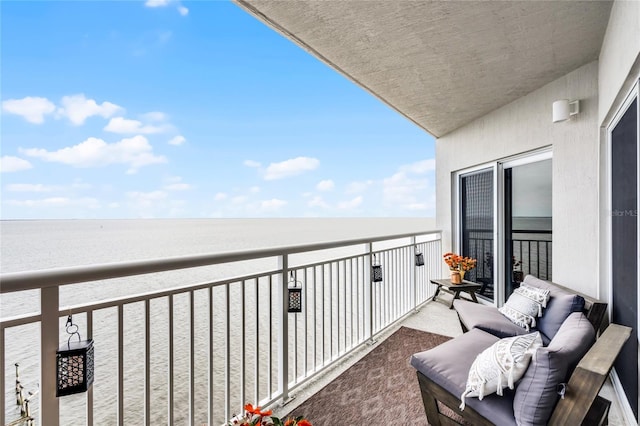 balcony featuring a water view and an outdoor hangout area