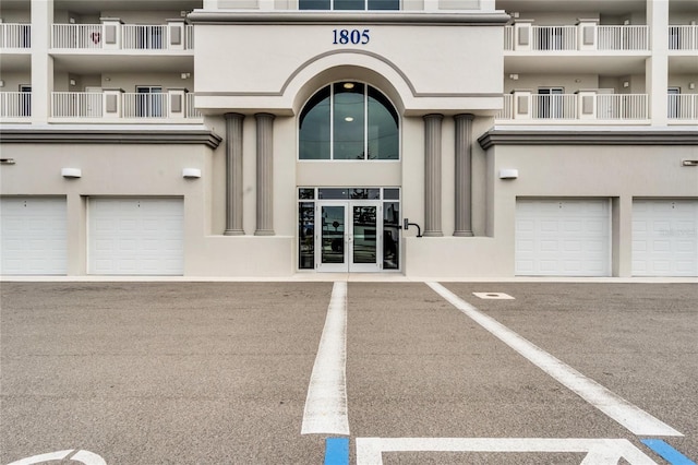 entrance to property with stucco siding and french doors