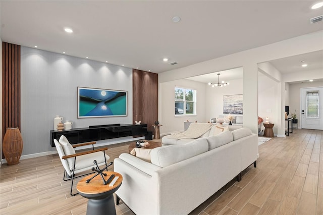 living room with plenty of natural light and an inviting chandelier