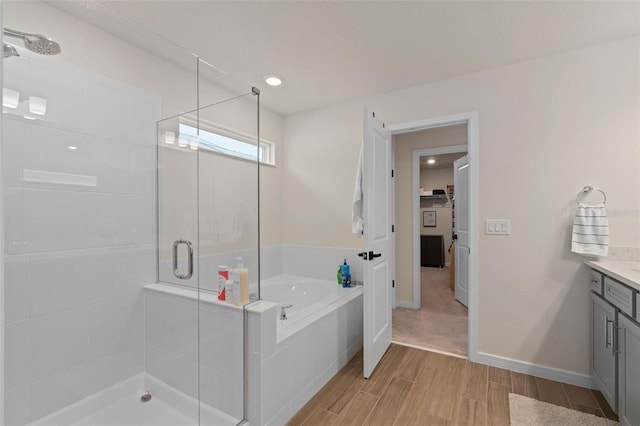 bathroom featuring plus walk in shower and vanity