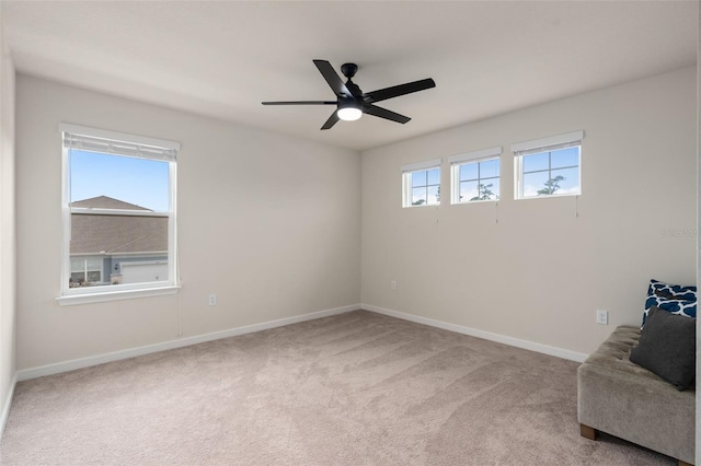 unfurnished room featuring ceiling fan, a healthy amount of sunlight, and carpet