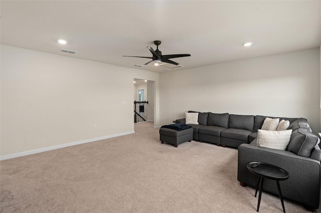 living room featuring light carpet and ceiling fan