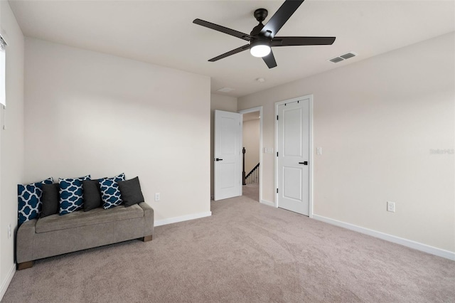 sitting room featuring light carpet and ceiling fan