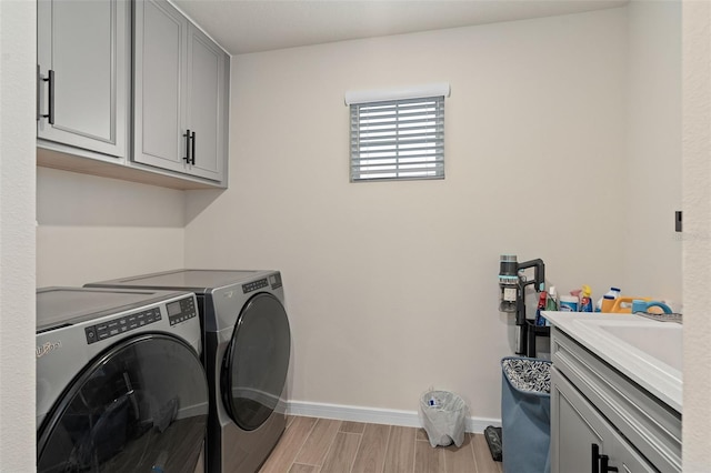 laundry area with cabinets and independent washer and dryer