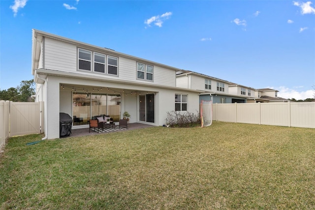 rear view of property with a patio and a yard