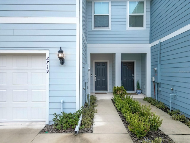 view of exterior entry with a garage