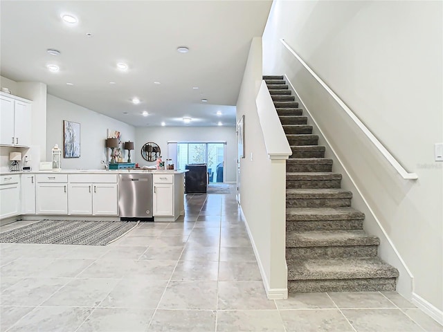 kitchen featuring white cabinetry, dishwasher, and light tile patterned floors