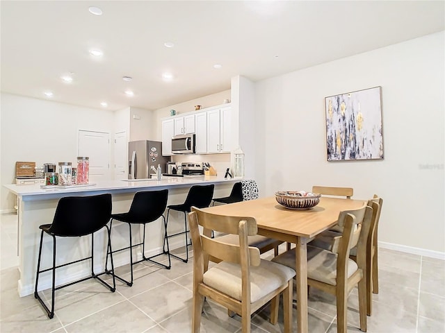 dining space with light tile patterned floors