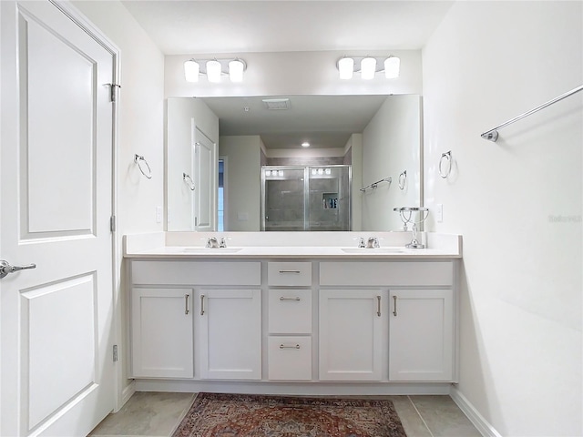 bathroom with tile patterned flooring, vanity, and a shower with shower door