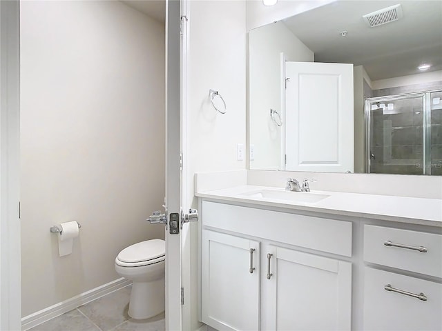 bathroom featuring tile patterned floors, vanity, toilet, and an enclosed shower