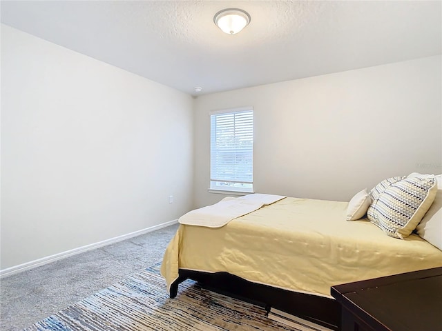 carpeted bedroom with a textured ceiling