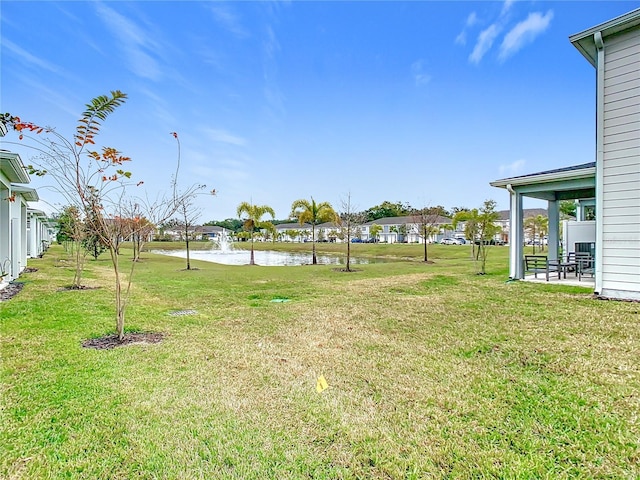 view of yard featuring a patio and a water view