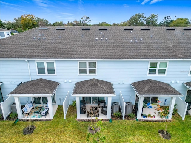 rear view of property featuring a gazebo, a lawn, a patio, and cooling unit