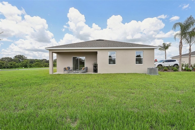 rear view of house with a patio area, a yard, and cooling unit