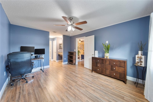 office with crown molding, ceiling fan, a textured ceiling, and light wood-type flooring