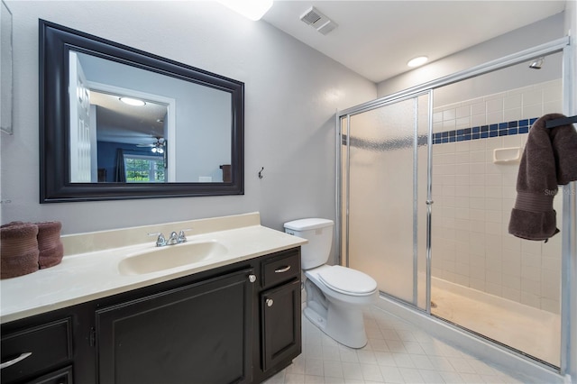 bathroom featuring vanity, an enclosed shower, and toilet