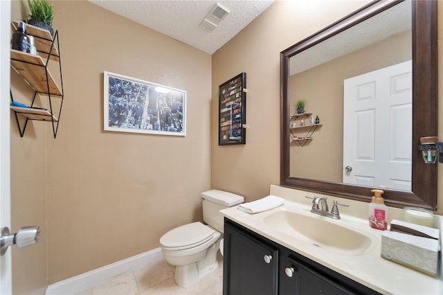 bathroom with vanity, tile patterned floors, a textured ceiling, and toilet