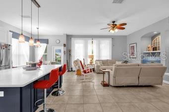 interior space featuring light tile patterned flooring and ceiling fan