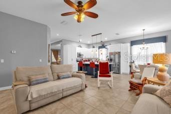 living room featuring ceiling fan and light tile patterned floors