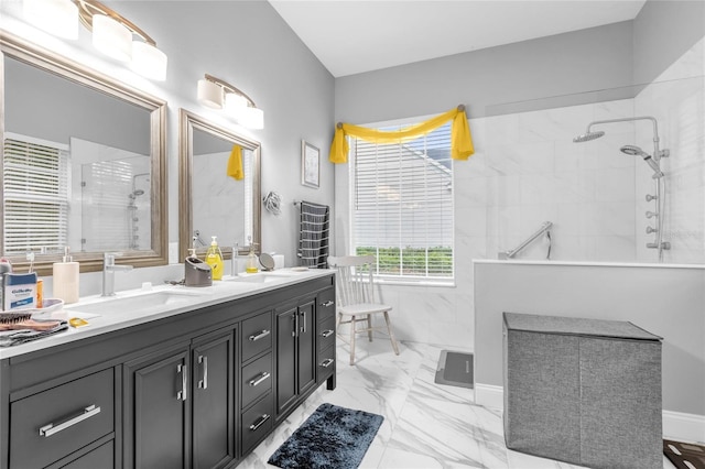 bathroom with vanity and a tile shower