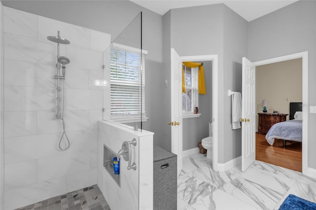 bathroom with toilet and tiled shower