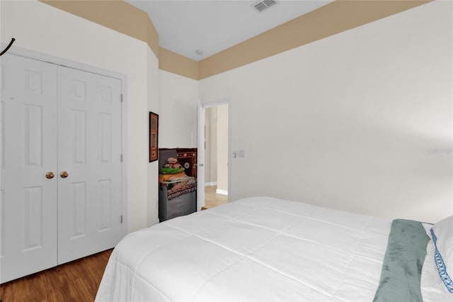 bedroom with hardwood / wood-style flooring and a closet