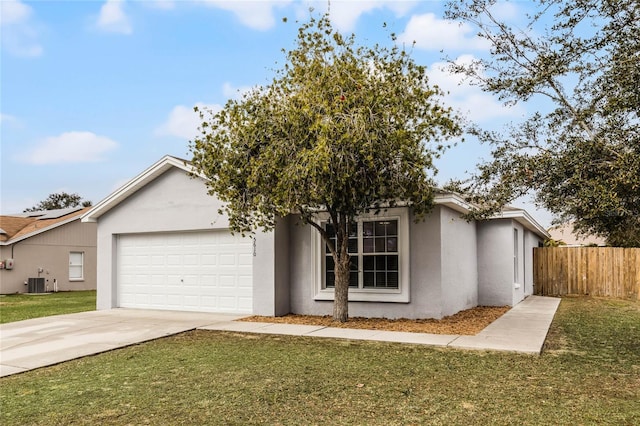 view of front facade with a garage, cooling unit, and a front yard