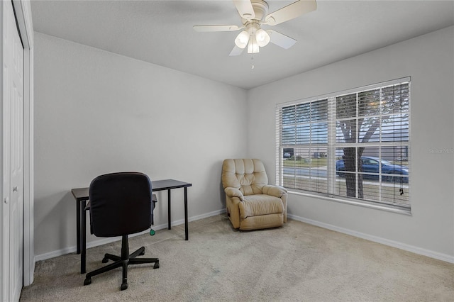 carpeted office space featuring a wealth of natural light and ceiling fan