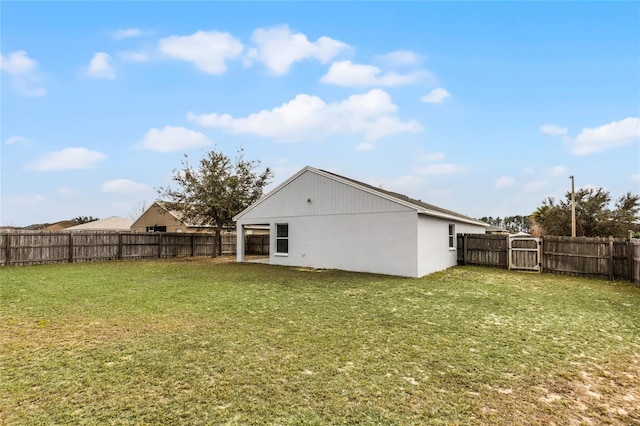 rear view of house with a yard