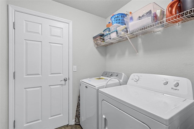 laundry area featuring separate washer and dryer and a textured ceiling