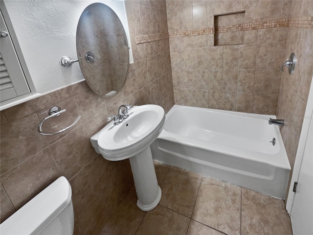 bathroom with shower / bathtub combination, tile patterned floors, toilet, and tile walls