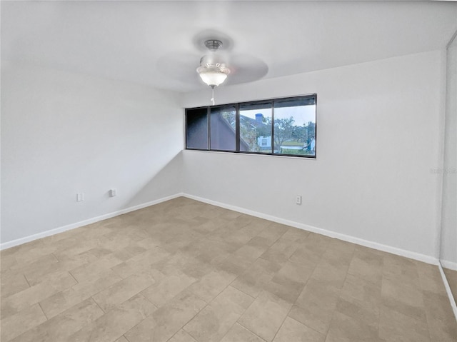 spare room with ceiling fan