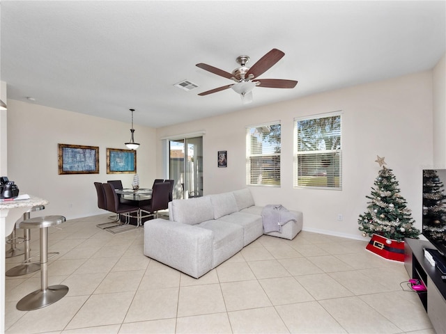 tiled living room featuring ceiling fan