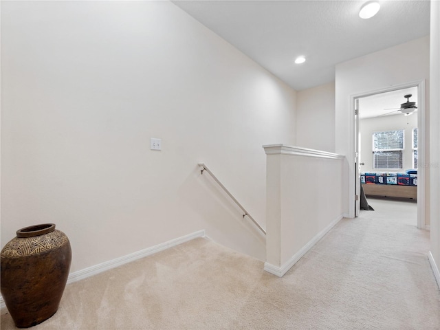 hall featuring light colored carpet