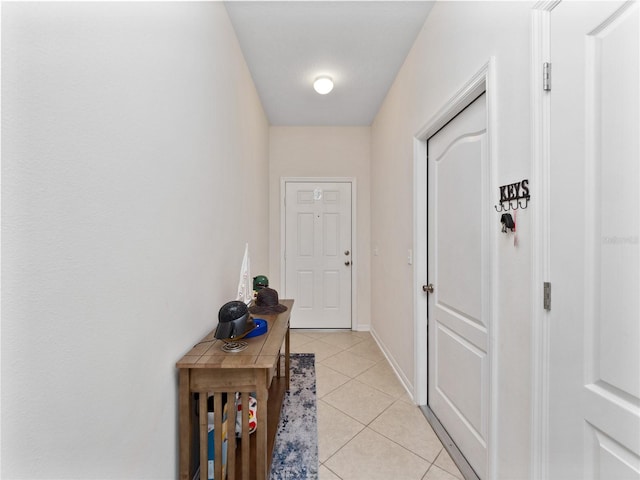 doorway to outside with light tile patterned flooring