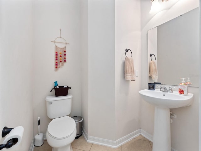 bathroom featuring sink, toilet, and tile patterned floors